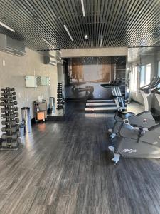 a gym with treadmills and machines in a room at Apto Brooklin ao lado do metro in Sao Paulo