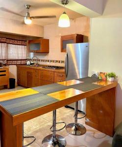 a kitchen with a stainless steel refrigerator and a counter at Hermoso departamento en Paseo Santa Lucia in Monterrey