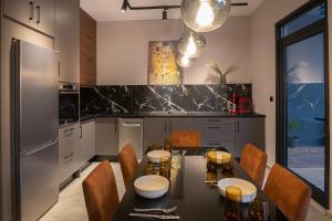 a kitchen with a dining room table and chairs at Maison 4 Seasons in Kalamata