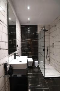 a bathroom with a sink and a shower at Maison 4 Seasons in Kalamata +16 photos