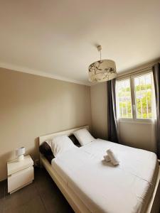 een slaapkamer met een wit bed en een raam bij Le soulier de notre dame in Marseille