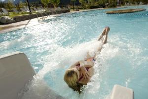 a girl laying on her back in a swimming pool at Panorama Mountain Resort - Ski Tip / Tamarack Condos in Panorama