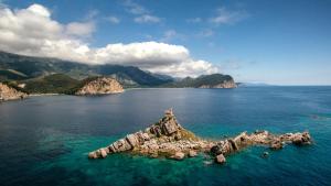 an island in the middle of a large body of water at Apartments Bonazza in Petrovac na Moru