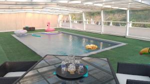 - une piscine avec une table dans une chambre dans l'établissement Le Domaine de la plume, à La Gimond