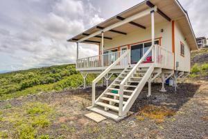 una casa en la ladera de una colina en Captain Cook Bungalow with Panoramic Ocean Views!, en Papa Bay Estates