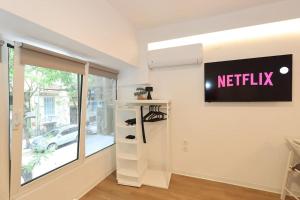 a dressing room with a netflix sign on the wall at Mini Suite Roman Agora in Thessaloniki