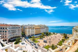 a view of a city with the ocean in the background at Mini Suite Roman Agora in Thessaloniki