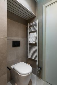 a bathroom with a toilet and a shower at Corfu Lux City in Agios Rokkos