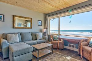 ein Wohnzimmer mit einem Sofa und einem Tisch in der Unterkunft Sea Gypsy Rentals in Lincoln City