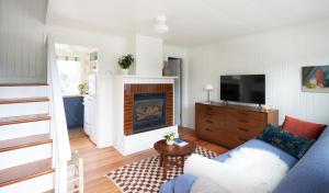 a living room with a blue couch and a fireplace at The Drifthaven at Gearhart in Gearhart