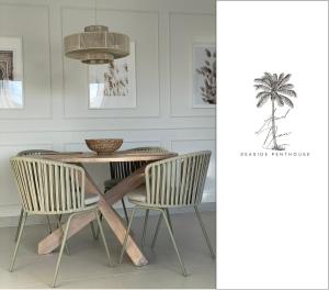 a dining room with a table and chairs and a palm tree at Arenal Dream Seaside Penthouse in Jávea