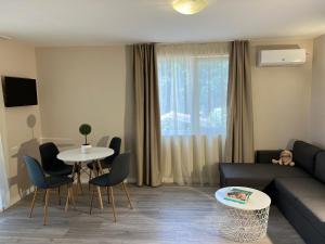 a living room with a couch and a table at Lotos Apartments in Kiten