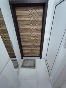 a room with a wooden ceiling and white floors at Апартамент Мелани in Varna City