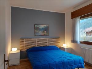 A bed or beds in a room at La Casetta nelle Dolomiti