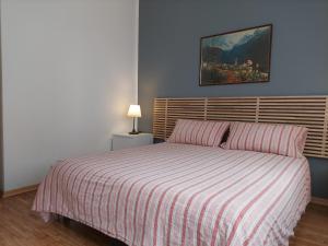 A bed or beds in a room at La Casetta nelle Dolomiti