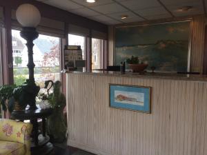 a lobby with a reception counter with a picture on the wall at Windswept Motel in Point Pleasant Beach