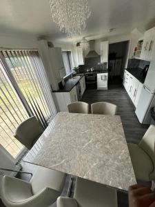 a kitchen with a table and chairs and a dining room at The Ebs Lodge 
