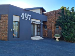 a blue house with the number on it at House Mulberry Guesthouse in Pretoria