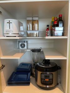 a kitchen pantry with a blender and other kitchen items at Glenelg resort style beachside apartment in Glenelg