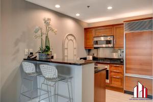 a kitchen with a counter with two stools at MGM Signature-32-621 1Br2Ba F1 Strip View Balcony in Las Vegas
