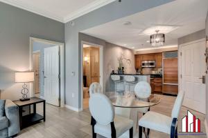 a dining room and living room with a table and chairs at MGM Signature-32-621 1Br2Ba F1 Strip View Balcony in Las Vegas