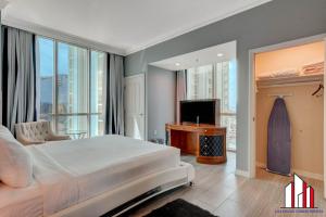 a bedroom with a large bed and a television at MGM Signature-32-621 1Br2Ba F1 Strip View Balcony in Las Vegas