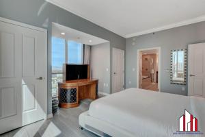 a bedroom with a bed and a flat screen tv at MGM Signature-32-621 1Br2Ba F1 Strip View Balcony in Las Vegas