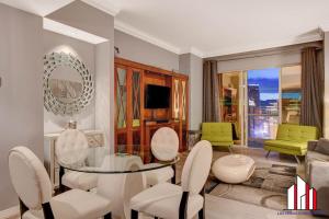 a living room with a glass table and chairs at MGM Signature-32-621 1Br2Ba F1 Strip View Balcony in Las Vegas