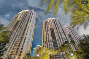 two tall buildings with palm trees in the foreground at MGM Signature-32-621 1Br2Ba F1 Strip View Balcony in Las Vegas
