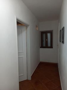 an empty hallway with a door and a window at Apartment Katarina in Risan