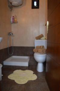 a bathroom with a toilet and a tub and a sink at Dimitris Afytos Apartment in Afitos