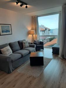 a living room with a couch and a coffee table at Port Lozenets Apartment in Lozenets
