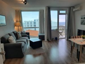 a living room with a couch and a table at Port Lozenets Apartment in Lozenets