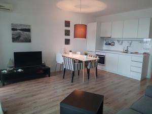 a living room with a table and a kitchen at Port Lozenets Apartment in Lozenets +4 photos
