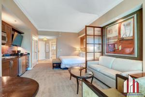 a living room with a couch and a bed at MGM Signature-33-705 F1 Track & Strip View Balcony in Las Vegas