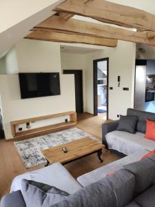 a living room with a couch and a table at Blue Door Apartment Loft in Augustów