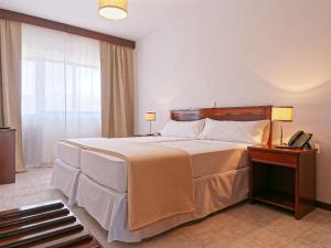 Cama ou camas em um quarto em Hotel Central Santa Maria