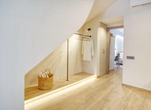 a hallway of a house with a staircase with a basket at Il Porto Blu in Chania Town +13 photos