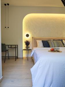 a bedroom with a bed with a tray of fruit on it at Il Porto Blu in Chania Town