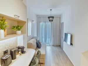 a kitchen and living room with white walls and a couch at Il Porto Blu in Chania Town