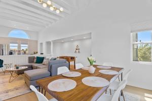 a dining room and living room with a table and chairs at Stylish Phoenix Townhome - Central Location & Sleeps 8 in Phoenix
