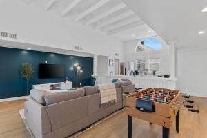 a living room with a couch and a table with a game at Stylish Phoenix Townhome - Central Location & Sleeps 8 in Phoenix