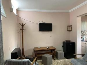 a living room with a tv on the wall at giomana in Borjomi