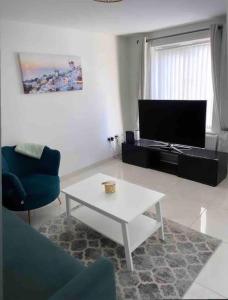 a living room with a coffee table and a tv at 3 stories, 5 BR House in Prime Location with balcony and shared Garden in Liverpool