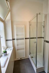 a bathroom with a glass shower and a sink at Fancy Home For 5 With Self-Check-In At Spittelberg in Vienna