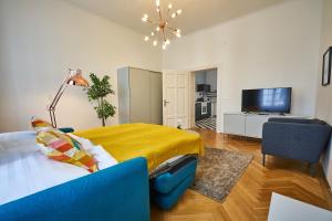 a bedroom with a bed and a television in it at Fancy Home For 5 With Self-Check-In At Spittelberg in Vienna
