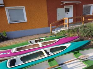 a group of boats parked next to a building at Apartment at the Vilzsee, Mirow in Diemitz