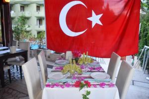a table with a turkey flag on top of it at Ares City Hotel in Kemer