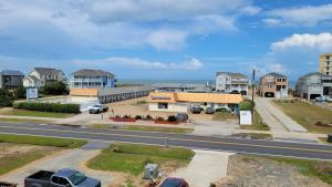 a view of a street with houses and the ocean at 8018 Beach Rd, Semi-Oceanfront, Pool/Hot Tub in Nags Head