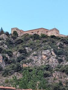a castle on the top of a mountain at Appartement Le Fort 2 Vue Montagne in Villefranche-de-Conflent